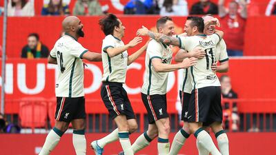 Liverpool's Mark Gonzalez (R) celebrates with teammates after scoring their second goal. AFP