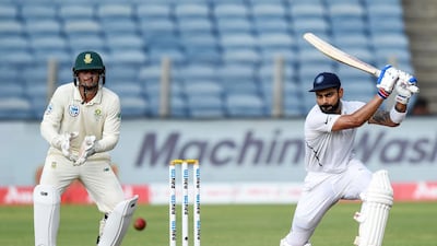 Indian captain Virat Kohli, right, plays a shot. AFP
