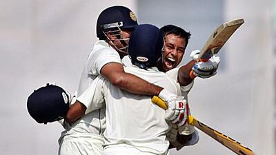 India’s VVS Laxman, left, Pragyan Ojha, right, and Suresh Raina celebrate their win over Australia on the final day of their first cricket Test match in Mohali.