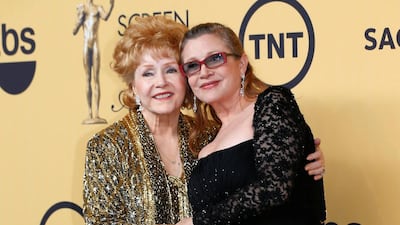 Actress Debbie Reynolds poses with her daughter actress Carrie Fisher backstage after accepting her Lifetime Achievement award at the 21st annual Screen Actors Guild Awards in Los Angeles, January 25, 2015. Reynolds died on Wednesday at age 84, a day after her daughter. Mike Blake / Reuters