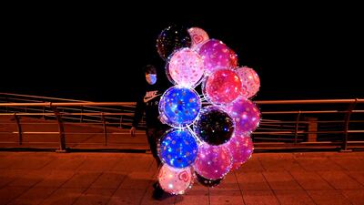 A street vendor sells colored balloons at Beirut's seaside corniche along the Mediterranean Sea, in Beirut, Lebanon. AP Photo