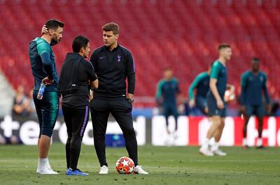 Tottenham manager Mauricio Pochettino speaks to goalkeeper Hugo Lloris, left, during a training session at the Wanda Metropolitano stadium. Bernat Armangue / AP Photo