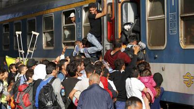 Migrants storm a train at the Keleti station in Budapest, Hungary. Laszlo Balogh / Reuters