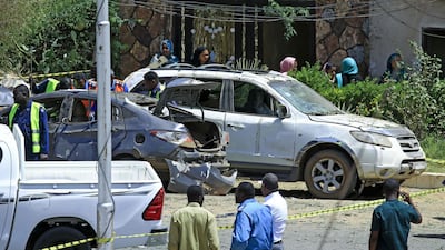 Sudanese rescue teams and security forces gather next to damaged vehicles at the site of an assassination attempt against Sudan's Prime Minister Abdalla Hamdok, who survived the attack with explosives unharmed, in the capital Khartoum. AFP