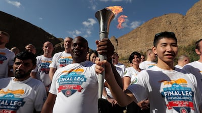 Volunteers , officials and staff members of Wadi Al Wurayah with the Special Olympics torch “Flame of Hope” in Wadi Al Wurayah Waterfalls in Fujairah. Pawan Singh/The National