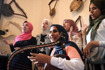 Iman Haddo, founder of the first all-female simsimiyya choir, plays the instrument at the Canal 20 museum in Port Said. AFP