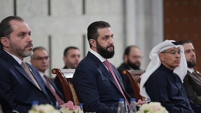 Syria's President Ahmad Al Shara, centre, and Dubai businessman Mohamed Alabbar, right, attend the signing ceremony for a deal to develop new projects, at the People’s Palace in Damascus. Sana / AFP