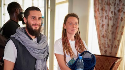 Italian Luca Tacchetto and Canadian Edith Blais are greeted by officials as they arrive at the airport in Bamako on March 14, 2020 after their release by UN peacekeepers. AFP
