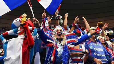 French fans cheer inside the Stade de France ahead of kick-off. Filip Singer / EPA