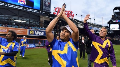 Sachin’s Blasters captain Sachin Tendulkar and Warne’s Warrors captain Shane Warne wave to fans after the T20 legends match on Saturday in New York City. Jewel Samad / AFP