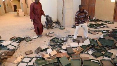 Men recover burnt ancient manuscripts at the Ahmed Baba Centre for Documentation and Research in Timbuktu.