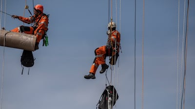 Workers begin the process of wrapping up the Arc De Triomphe. Getty Images