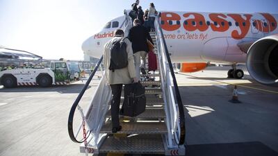 Passengers board an EasyJet aircraft on the tarmac at London Southend Airport. Simon Dawson / Bloomberg
