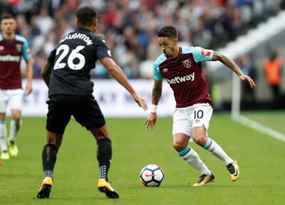 West Ham United's Manuel Lanzini, right, in action with Swansea City's Kyle Naughton. Hannah McKay / Reuters