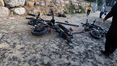 People stand by damaged bicycles near the reported strike from Lebanon fell in Majdal Shams village. AFP