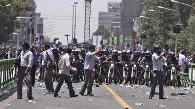 Members of the Bassij militia and riot police on motorbikes clash with protesters during Friday prayers in Tehran on July 17.
