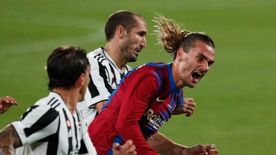 Barcelona's Antoine Griezmann in action with Juventus' Giorgio Chiellini.