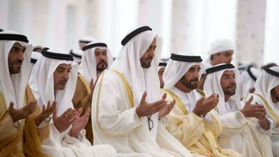 Sheikh Mohammed bin Zayed, centre, prays with, from left to right, Sheikh Nahyan Bin Zayed, Sheikh Hazza bin Zayed, Sheikh Saif bin Mohammed and Sheikh Suroor bin Mohammed. Hamad Al Kaabi / Crown Prince Court - Abu Dhabi
