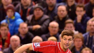 Liverpool's English midfielder Steven Gerrard, centre, is being offered a new contract. Paul Ellis / AFP