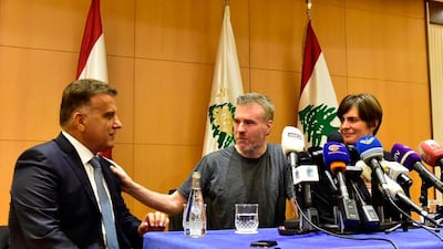 This handout photo by the Lebanese General Security Directorate, shows Maj. Gen. Abbas Ibrahim, left, Lebanon's General Security Chief, speaks with Canadian citizen Kristian Lee Baxter, center, who was released from Syrian prisons to Lebanon, during a press conference in Beirut, Lebanon.