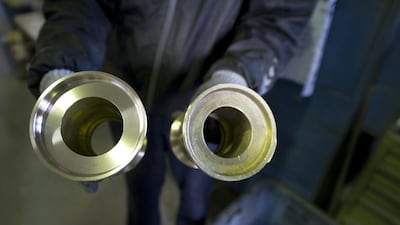 A workers shows a raw and polished metal product at the Nousaka metal crafts factory in Takaoka. Everett Kennedy Brown / EPA