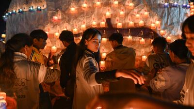 Participants preparing candles as they set up a hot air balloon to be released loaded with fireworks during the Tazaungdaing Lighting Festival in Taunggyi in Myanmar's northeastern Shan State. AFP