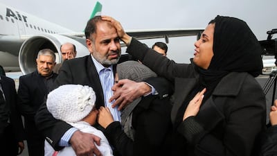 Iranian diplomat Nour Ahmad Nikbakht, abducted in Yemen in 2013, is embraced by his daughters at Mehrabad airport on his return to Tehran after being freed by Iranian special forces. Amir Pourmand / ISNA / AP Photo