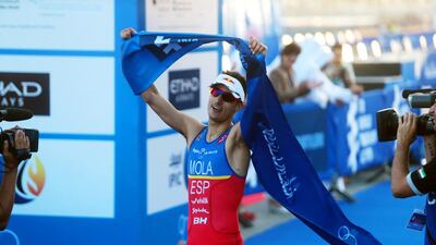 Mario Mola of Spain celebrates winning the elite male IPIC World Triathlon at the Corniche in Abu Dhabi on March 7. Christopher Pike / The National