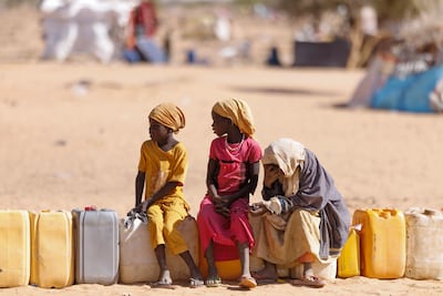 Children wait for water at the Oure Cassoni refugee camp after arriving from Sudan, on February 23, 2026 in Oure Cassoni, Chad. Getty Images
