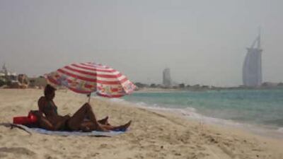 A couple enjoys an afternoon at the Jumeirah beach in Dubai.