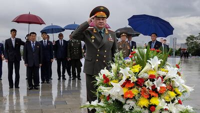 Mr Shoigu salutes before the statues of the late North Korean leaders Kim Il-sung and Kim Jong-il at Mansu Hill in Pyongyang. AFP