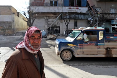 A Syrian man walks past the site a suicide attack which killed four US serviceman in Manbij, northern Syria. AFP