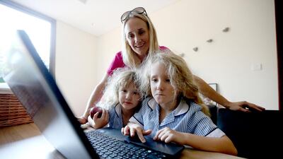 Kay Jones-Swift with her 6-year-old twins, Mia and Annabel, who are frequent users of Mathletics and find it a fun way to practise maths. Fatima Al Marzooqi / The National