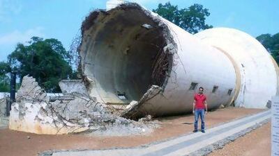 War relics, such as this destroyed water tank in Jaffna, where Mobisher Rabbani stands, have become popular destinations in Sri Lanka. Courtesy of Mobisher Rabbani