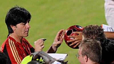Germany's coach Joachim Loew signs autographs during training ahead of Tuesday's 7-2 friendly victory over the UAE in Dubai.