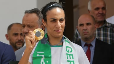 Algerian boxer Imane Khelif shows off her Olympic gold medal upon her arrival at the airport in Algiers, Algeria August 12, 2024. Reuters