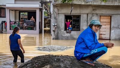 Residents stay inside their homes flooded by Super Typhoon Noru in San Ildefonso, Bulacan province, Philippines. Getty Images