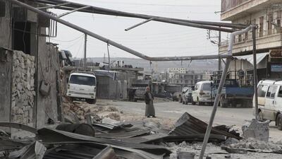 A man walks near damage in Kafr Hamra village, northern Aleppo countryside. Abdalrhman Ismail / Reuters