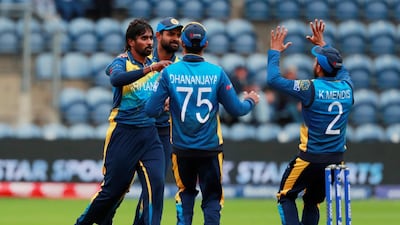 Sri Lanka's Nuwan Pradeep, left, celebrates with teammates after taking the wicket of Afghanistan's Hashmatullah Shahidi. Reuters