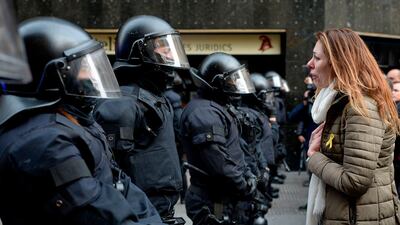 A protester cries as she speaks to riot police blocking the road leading to the central government offices at a demonstration in Barcelona, Spain, on March 25, 2018. Josep Lago / AFP Photo