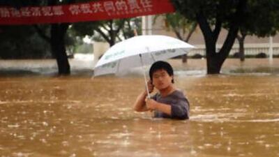 China's National Meteorological Centre warned that several counties in Jiangxi province had been reduced to islands isolated by flood water. Above, a street in Yujiang county.