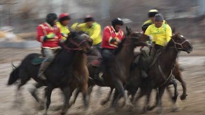 Kyrgyz riders play the traditional Central Asian sport of Kok boru (Gray Wolf) or Buzkashi (Goat Grabbing) in Cholpon-Ata near Issyk Kule lake some 250kms from Bishkek. Riders compete for points by throwing a stuffed sheepskin into a well in games dedicated to the celebration of Nowruz. AFP