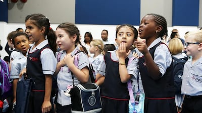 Pupils wait to go in their classes on the first day of school at the Dubai British School in Jumeirah Park, Dubai. Pawan Singh / The National