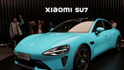 Xiaomi's SU7 during its unveiling in Beijing in December 2023. The company said its first electric vehicle has a range of up to 800 kilometres. Reuters