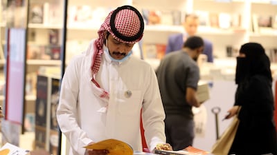 A Saudi man peruses a book at the Riyadh International Book Fair