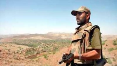 A Pakistani soldier patrols in the district of South Waziristan, where officials said six people were killed yesterday in a US missile strike.