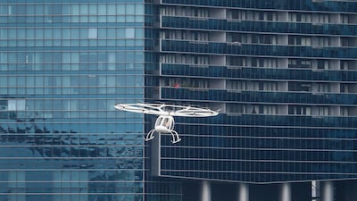 A Volocopter air taxi flies past a building during its test flight in Singapore. The Volocopter is a manned, electric powered multicopter. EPA