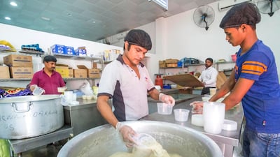 Cooks begin to portion up the porridge that they will hand out later in the evening.