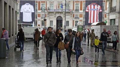 Posters of Real Madrid and Atletico Madrid jerseys hang at Puerta del Sol square in Madrid where the game will be screened for those fans who could not make the trip to Portugal. Andrea Comas / Reuters