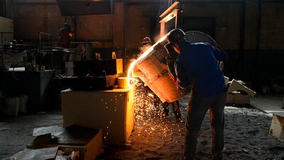 Workers pour molten steel into a mould at a foundry in Berdyansk, Zaporizhzhia region, in an area under Russian military control. AP